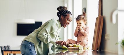 Woman and small child eating on kitchen island